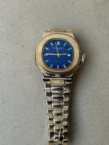 Patek Philippe Nautilus watch with a rose gold case and a blue dial