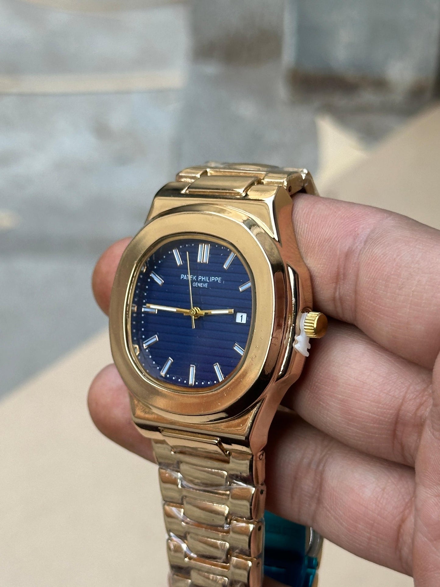 Patek Philippe Nautilus watch with a rose gold case and a blue dial